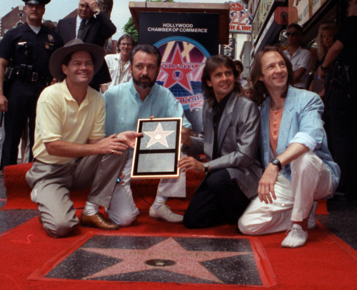 The Monkees, (from left) Micky Dolenz, Mike Nesmith, Davy Jones and Peter Tork, get a star on the Hollywood Walk of Fame in Los Angeles in 1989. (AP-Yonhap News)