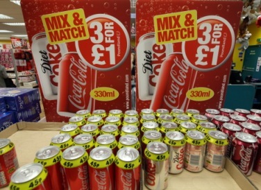 Cans of Coca Cola soft drinks sit on display at a Poundland discount store in Croydon, U.K., on Wednesday, Feb. 1, 2012. Poundland Holdings Ltd. operates houseware and toy retailers and is based in the United Kingdom. (Bloomberg)