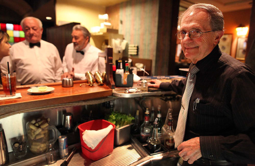 Bartender Fernando Gomez (right) and servers Jose Fragoso and Bernard Inchauspe (left) have worked for decades at the French restaurant Taix in Los Angeles, California’s Echo Park neighborhood. (Los Angeles Times/MCT)