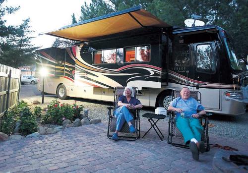 Mike (left) and Casey Venning of Napa, relax in front of their Monaco motor coach at Ventura Ranch, a KOA campground in Santa Paula, California, Feb. 9. (Los Angeles Times/MCT)