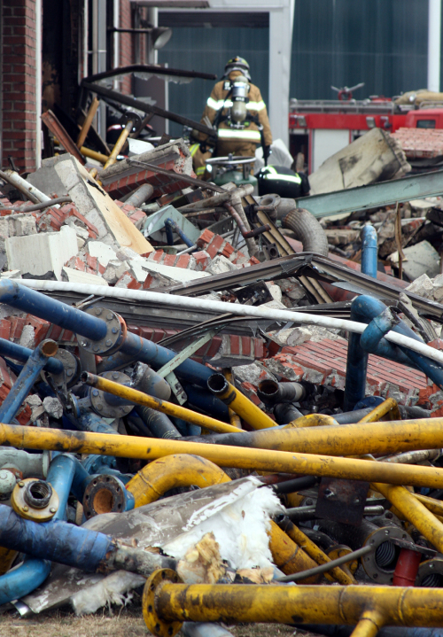 A firefighter walks through the debris of a water treatment center in Goyang, Gyeonggi Province, that was struck by a gas explosion Friday. (Yonhap News)