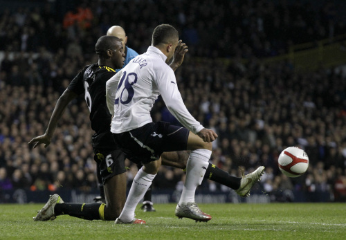 Bolton Wanderers' Fabrice Muamba, left, kicks the ball beside Tottenham's Kyle Walker, right, during the English FA Cup quarterfinal soccer match at White Hart Lane stadium in London, Saturday, March 17, 2012. (AP)