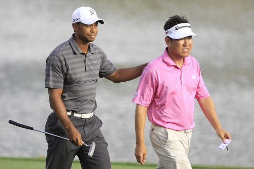 Tiger Woods (left) and Charlie Wi walk off the 18th green after finishing their third round of the Arnold Palmer Invitational golf tournament at Bay Hill in Orlando, Florida, Saturday. (AP-Yonhap News)