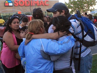 People embrace each other after strong earthquake hits Chile. (AP-Yonhap News)