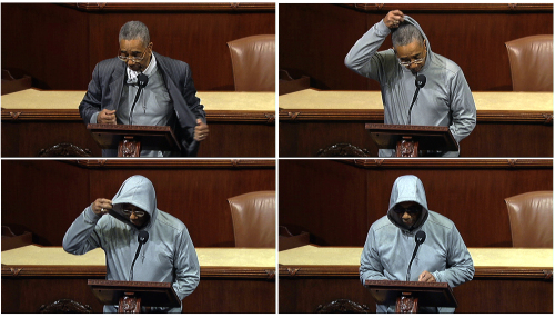 This series of handout frame grabs from video, provided by House Television shows Rep. Bobby Rush, D-Ill., taking off his jacket to wear a a hoodie and sunglasses as he speaks on the floor of the House on Capitol Hill in Washington, Wednesday (AP-Yonhap News)