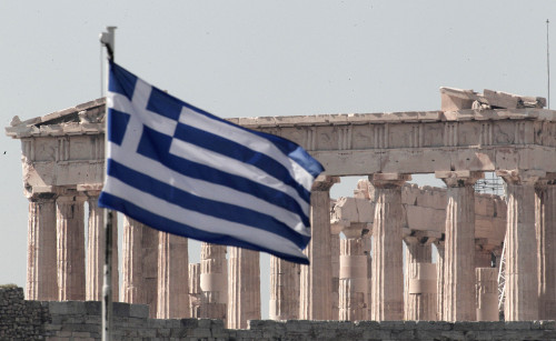 The temple of Parthenon is seen on top of the Acropolis hill in Athens as the Greek flag waves on Sunday. (AP-Yonhap News)