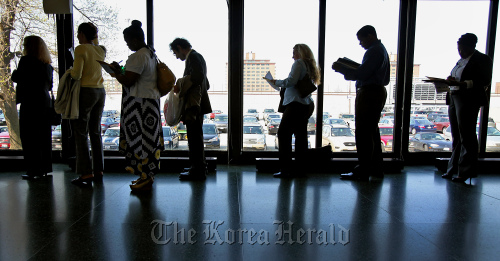 Job seekers stand in a line at the 12th Annual Diversity Employment Day Career Fair in Chicago. (Bloomberg)