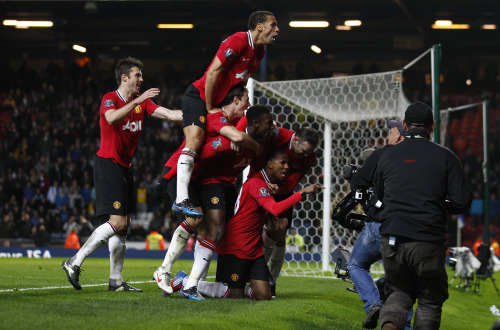 Manchester United’s Ashley Young (bottom) celebrates his goal with teammates. (AP-Yonhap News)