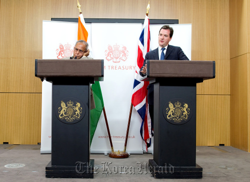 George Osborne (right), U.K. chancellor of the exchequer, speaks as Pranab Mukherjee, India’s finance minister, listens during their joint news conference at the Foreign and Commonwealth Office in London last year. (Bloomberg)1