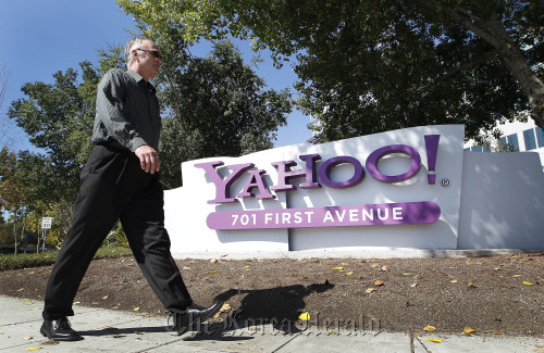 A pedestrian walks past Yahoo! Inc. signage displayed outside of company headquarters in Sunnyvale, California. (Bloomberg)
