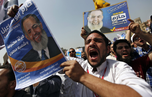 Egyptian protesters chant slogans holding posters of presidential candidate, Hazem Abu Ismail, which read, “ Hazem Abu Ismail is the President of the Republic. Respectable Country, protected people,” during a rally in Tahrir Square in Cairo on Friday. (AP-Yonhap News)