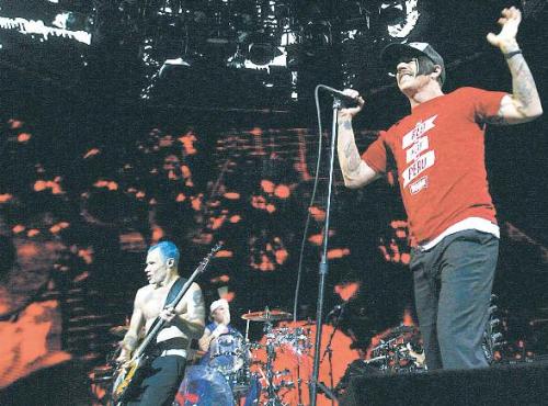 The Red Hot Chili Peppers (left to right), bassist Flea, drummer Chad Smith and lead singer Anthony Kiedis, perform at the Amway Center in Orlando, Florida, March 31. (MCT)