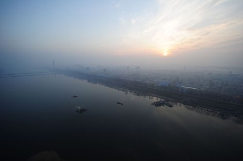 The sun rises above the Pyongyang city skyline on April 13, 2012. (AFP)