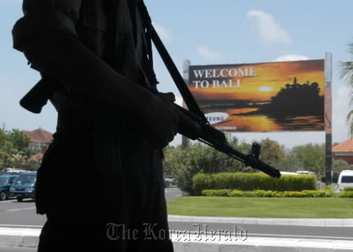 An Indonesian policeman patrols Bali’s international airport. (Bloomberg)