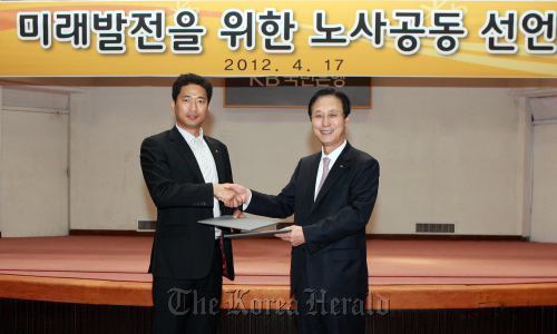 KB Kookmin Bank CEO Min Byong-deok (right) and KB labor union chief Park Byung-kwon make a joint announcement after a signing ceremony Tuesday. (KB Kookmin Bank)