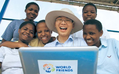 A World Friends Korea volunteer poses with children. (Korea International Cooperation Agency)