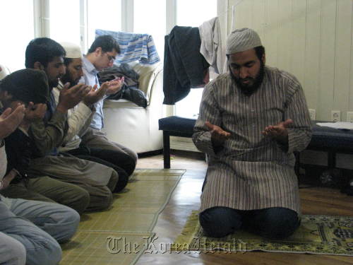 Naveed Ejaz (right) leads Muslim students attending Sejong University during Friday prayers in February. (Rob York/The Korea Herald)