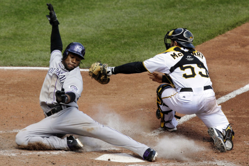 Colorado Rockies’ Eric Young Jr. (left) slides around the tag by Pittsburgh Pirates catcher Michael McKenry in the eighth inning of a baseball game in Pittsburgh on Wednesday. (AP-Yonhap News)