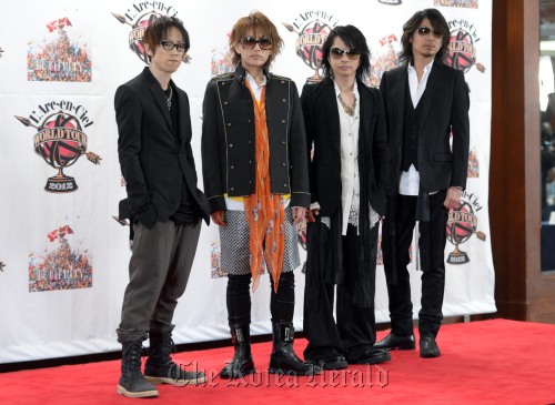 (From left) Drummer Yukihiro, bassist Tetsuya, vocalist Hyde and guitarist Ken of the Japanese rock band L’Arc-en-Ciel pose for photos at a news conference on Friday in Seoul. (Kim Myung-sub/The Korea Herald)