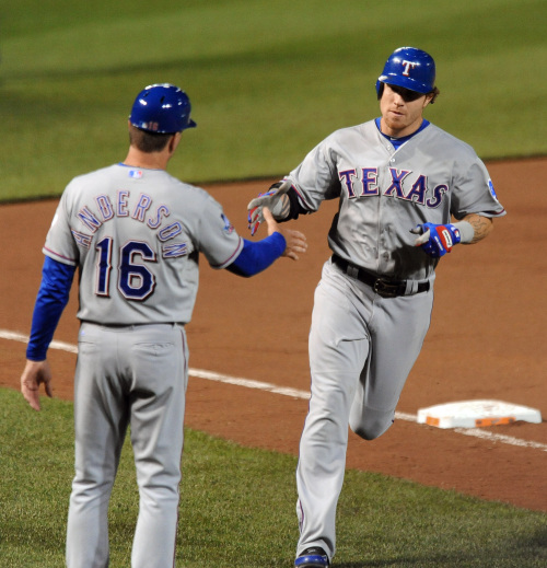 The Texas Rangers’ Josh Hamilton is congratulated by third-base coach Dave Anderson after his fourth homer. (MCT)
