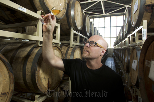 Lance Winters, owner and distiller of St. George Spirits in Alameda, California, checks the color of his hand-crafted whiskey at the company’s headquarters, April 17. (Contra Costa Times/MCT)