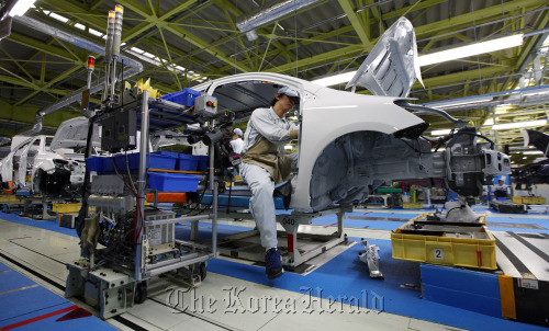 A worker assembles a Toyota Motor Corp. Corolla Axio sedan on the production line of the Central Motor Corp. plant in Ohira village, Miyagi Prefecture, Japan. (Bloomberg)