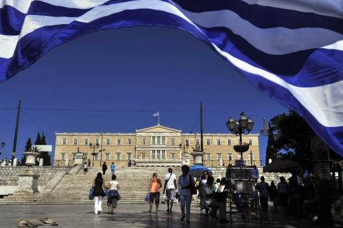 People walk at a central Athens square in front of the Greek parliament. (AFP-Yonhap News)