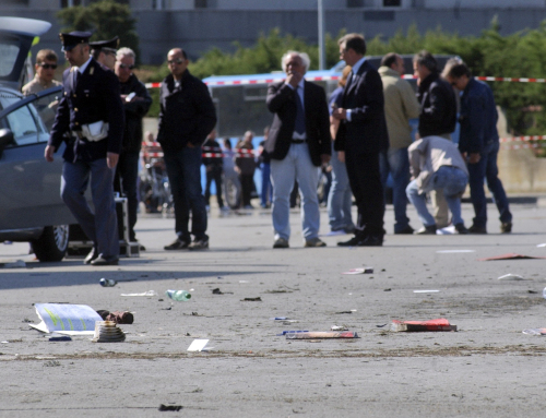 Italian policemen (background left) walk on the site where an explosive device went off outside “Francesca Morvillo Falcone” high school in Brindisi on Saturday. (AP-Yonhap News)