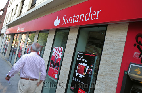 A pedestrian walks past a branch of Banco Santander SA in Madrid. (Bloomberg)