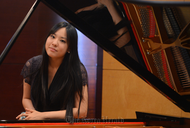 Pianist Lim Hyun-jeong poses at her piano during her album showcase held in Seoul, Tuesday. (Lee Sang-sub/The Korea Herald)