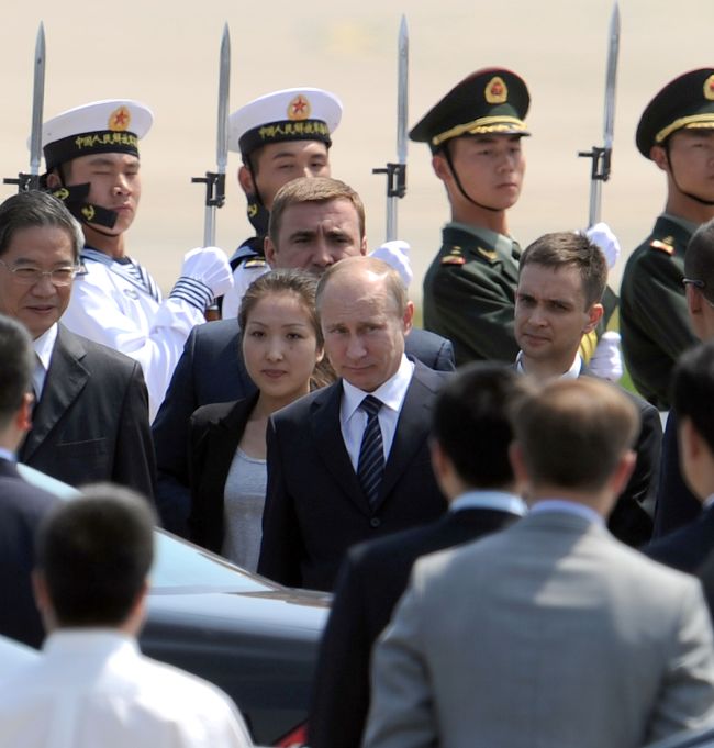 Russian President Vladimir Putin (center) walks to his car upon his arrival at the Beijing International Airport on Tuesday. (AFP-Yonhap News)