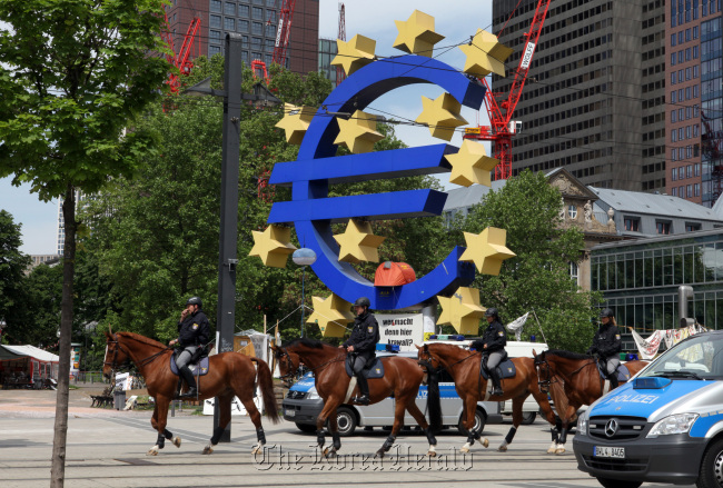 Police officers are seen on horseback in front of the European Central Bank's headquarters in Frankfurt, Germany, May 17. (Bloomberg-Yonhap News)