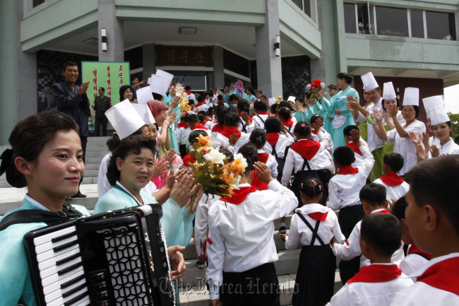 North Korean students selected as delegates to the Korean Children`s Union are welcomed as they arrive for lunch at a restaurant in Pyongyang, North Korea, Sunday. (AP-Yonhap News)