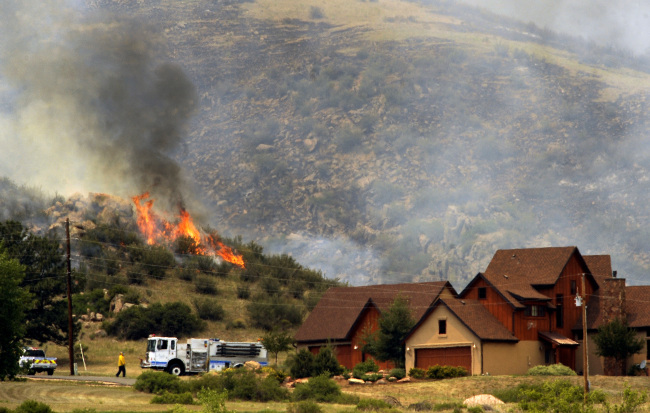 Poudre Fire Authority crews battle a wildfire in a mountainous area about 15 miles west of Fort Collins, Colorado on Sunday. (AP-Yonhap News)