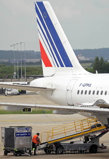 A ground crew employee loads baggage onto an Air France airplane at Orly Airport in Paris. (Bloomberg)