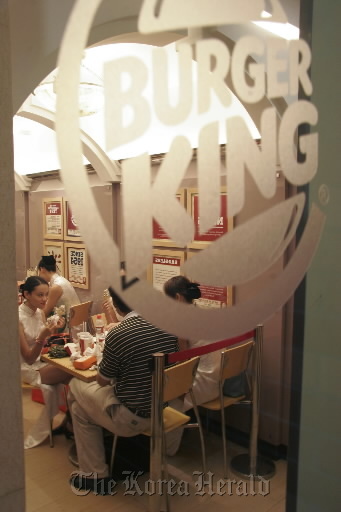 Customers eat their meals at a Burger King restautant in Shanghai. (Bloomberg)