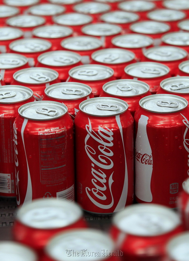 Coca-Cola Co. cans move along a conveyor belt at the company’s Swire bottling plant in Salt Lake City, Utah. (Bloomberg)