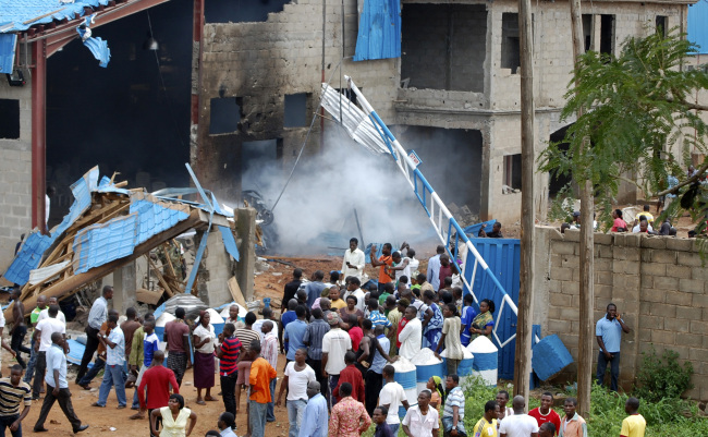 People gather outside a church following a blast in Kaduna, Nigeria, Sunday. (AP-Yonhap News)