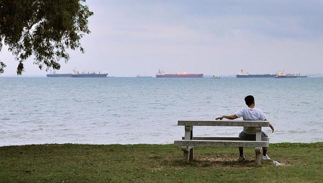 A man on a bench on the seashore. (Straits Times)