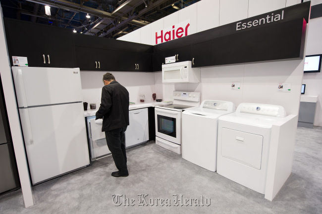 An attendee looks at durable goods made by the Haier Group at the International Consumer Electronics Show in Las Vegas, Nevada. (Bloomberg)