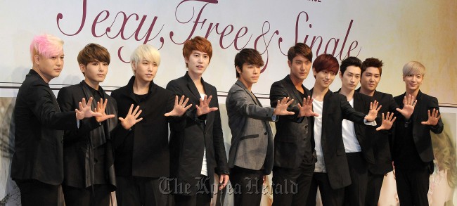 Members of Super Junior pose for photo at a news conference for their new album in Seoul, Tuesday. Lee Sang-sub/The Korea Herald