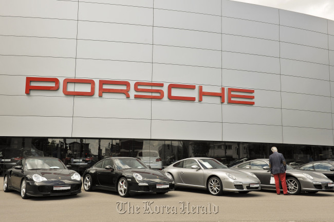 A customer browses Porsche 911 automobiles on display outside a dealership in Stuttgart. (Bloomberg)