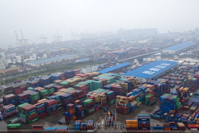 Containers are stacked at the Dayaowan Bonded Port Area in Dalian, Liaoning Province, China. (Bloomberg)