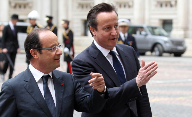 French President Francois Hollande (left) is greeted by Britain’s Prime Minister David Cameron at the Foreign and Commonwealth Office in London on Tuesday. (AP-Yonhap News)