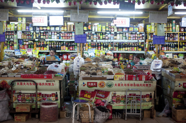 Vendors await customers in the dry goods section of a market in Beijing. (Bloomberg)