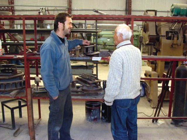 A former Sony engineer gives instructions to a local engineer at a factory in Marcos Juarez, Argentina, in 2010. (AFP)