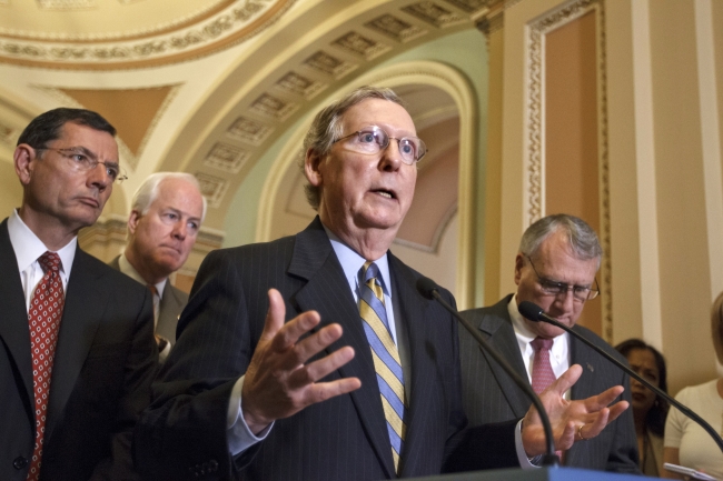 Senate Minority Leader Mitch McConnell (center) gestures during a news conference on Capitol Hill in Washington on Wednesday. (AP-Yonhap News)