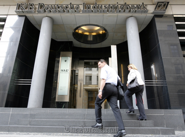 Employees enter an IKB Deutsche Industriebank AG branch in Berlin. (Bloomberg)