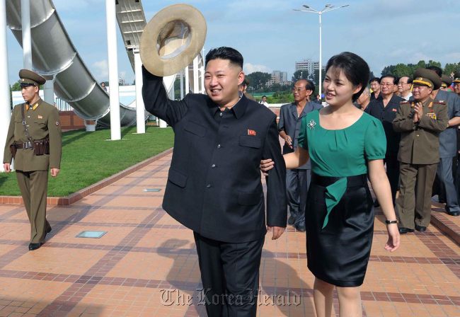 North Korean leader Kim Jong-un (center) and his wife Ri Sol-ju (right) attend the opening ceremony of the Rungna People‘s Pleasure Ground on Rungna Islet along the Taedong River in Pyongyang, Wednesday. (AP-Yonhap News/KCNA via KNS)