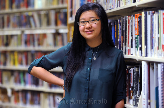 Keish Kim, 20, graduated from Centennial High School in Roswell, Georgia, in 2009. Kim wants to be a lawyer and was accepted to the state’s most competitive schools, but couldn’t attend because she couldn’t afford out-of-state tuition. Kim poses on June 27 for a photo at the Northeast/Spruill Oaks Library, in Johns Creek. (Atlanta Journal-Constitution/MCT)